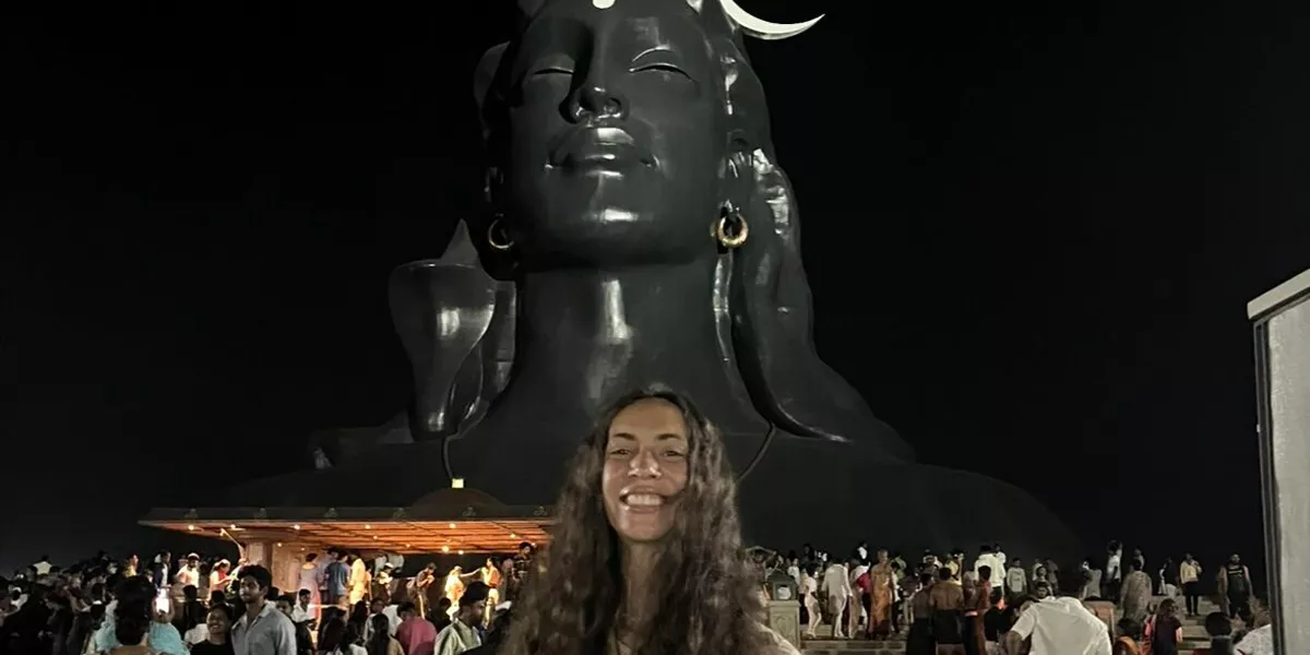 Woman Standing In Front Of Statue