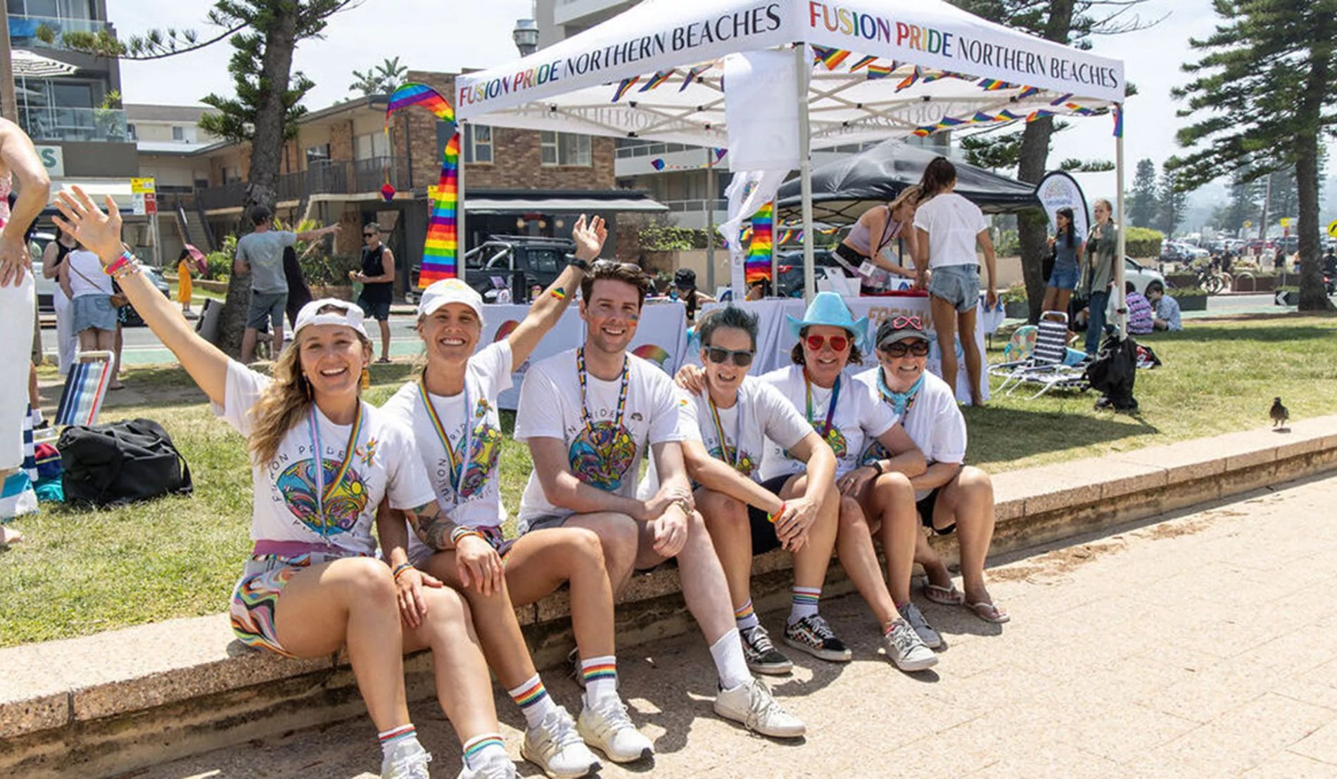 Group Of Friends Sat Outside Fusion Pride Tent