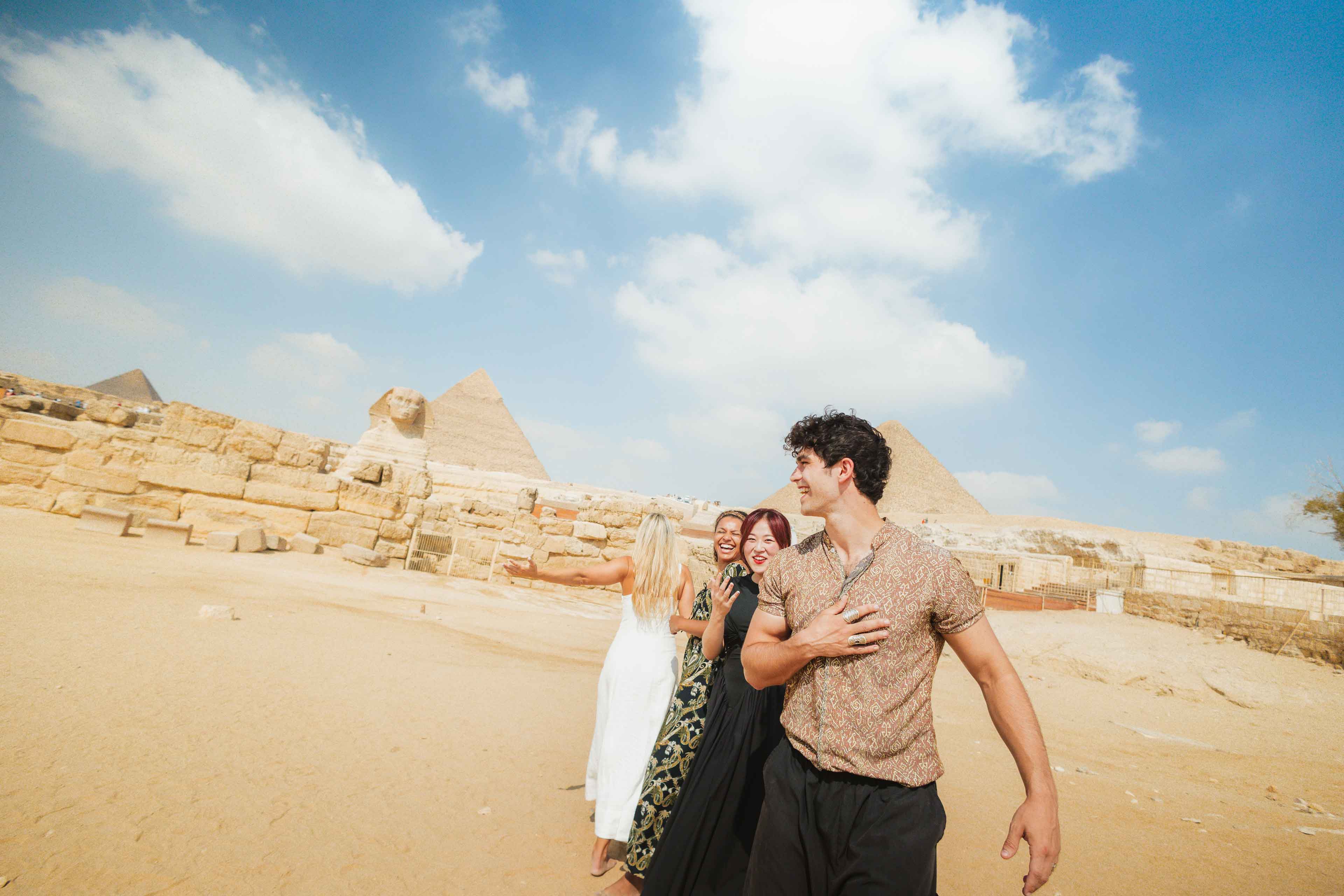 Smiling Travellers In Front Of The Sphinx In Egypt