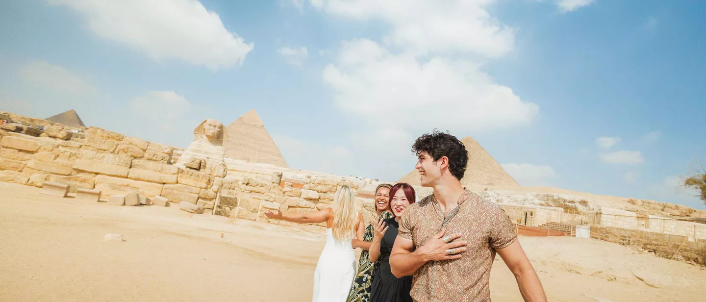 Smiling Travellers In Front Of The Sphinx In Egypt
