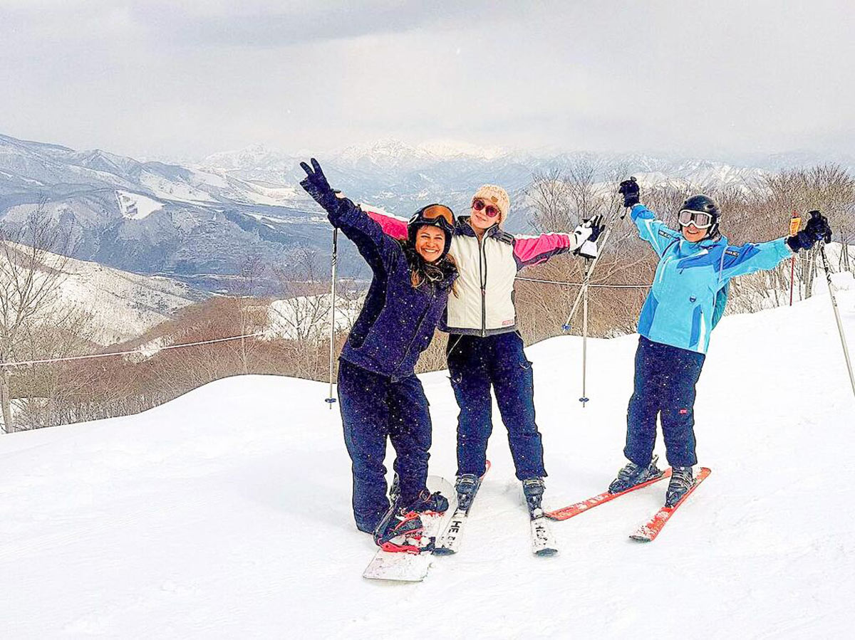 Three Friends Skiing Snow Falling