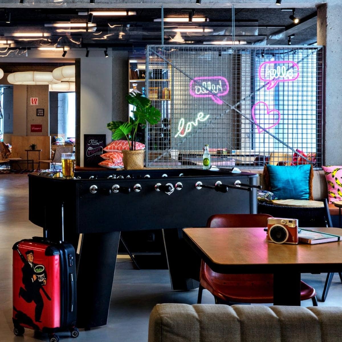 Moxy Paris Bastille game room with relaxation spaces, table football and colurful neons 
