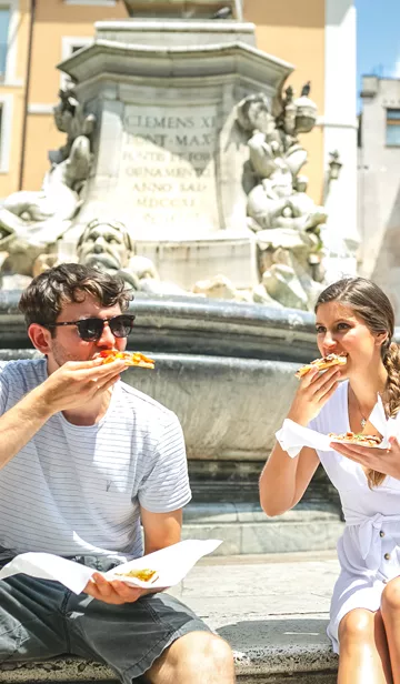 Travellers eating pizza