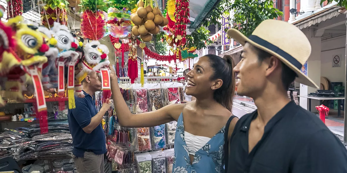 People Smiling While Looking At Souvenirs