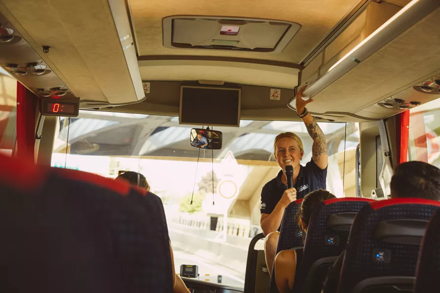 Trip Manager Talking To People In A Bus