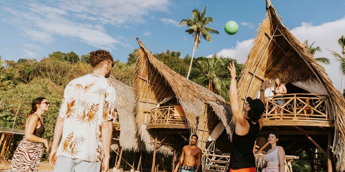 Isla Experiences Group Playing Volleyball On Beach Philippines