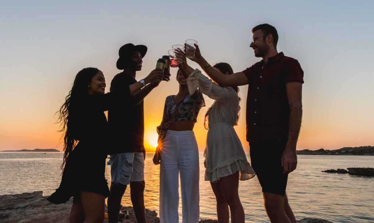 Youngsters are Toasting on the Beach at Sunset