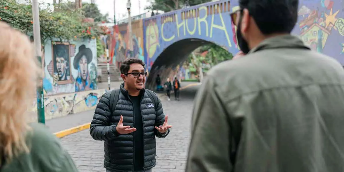 Tour Guide In Peru With Group Of Travelers
