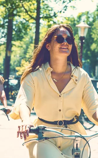 Contiki travellers cycle along Amsterdam's tree-lined canals on the European Whirl Tour