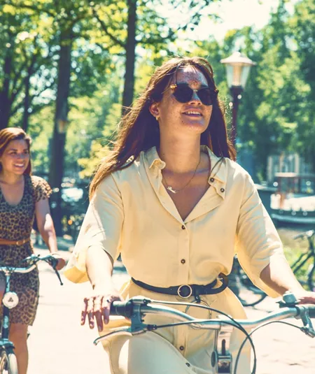 Contiki travellers cycle along Amsterdam's tree-lined canals on the European Whirl Tour