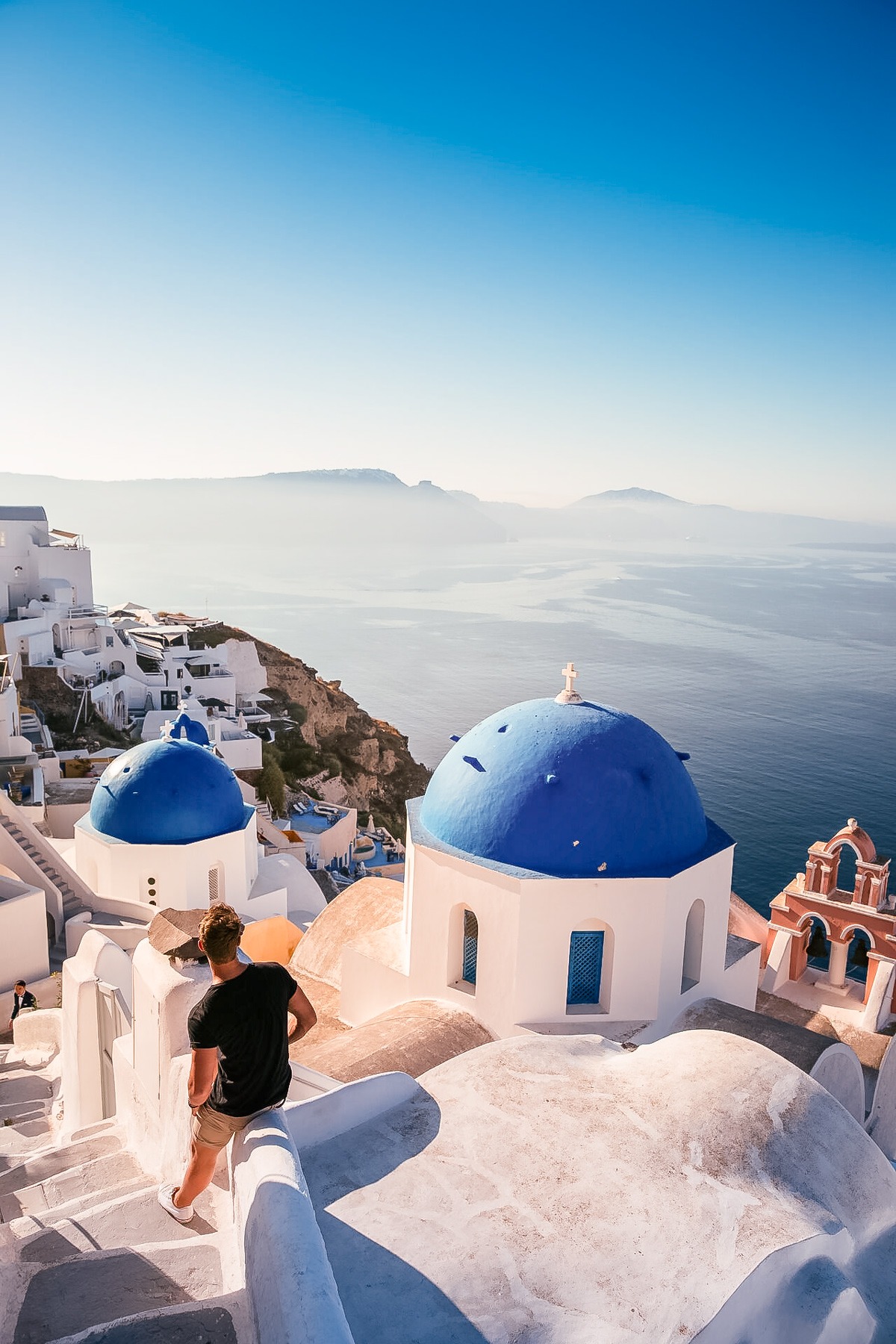 Man looking at blue sea from hill sunny day in Greece.