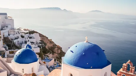 Man looking at blue sea from hill sunny day in Greece.