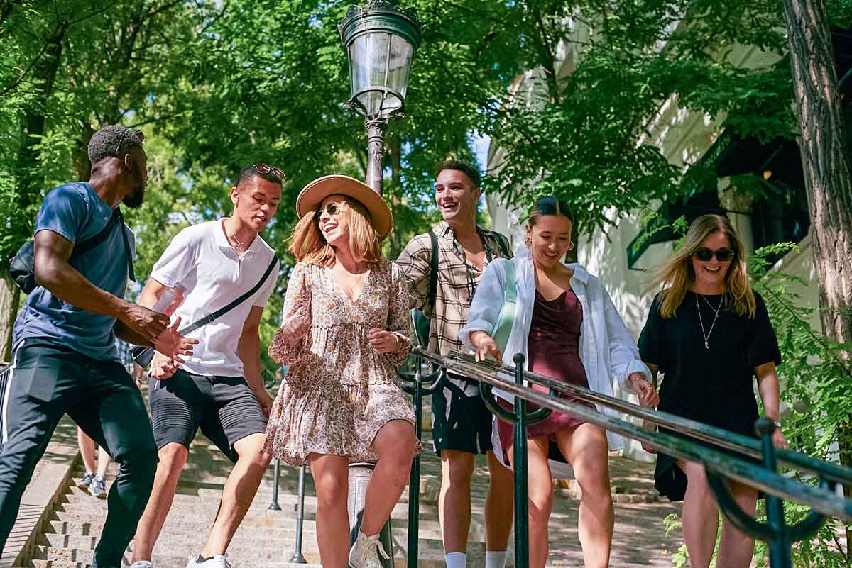 Group Of Travelers Exploring Paris In Summer