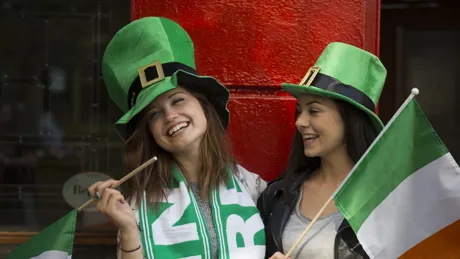Two Girls Wearing Irish Hats Holding Irish Flags
