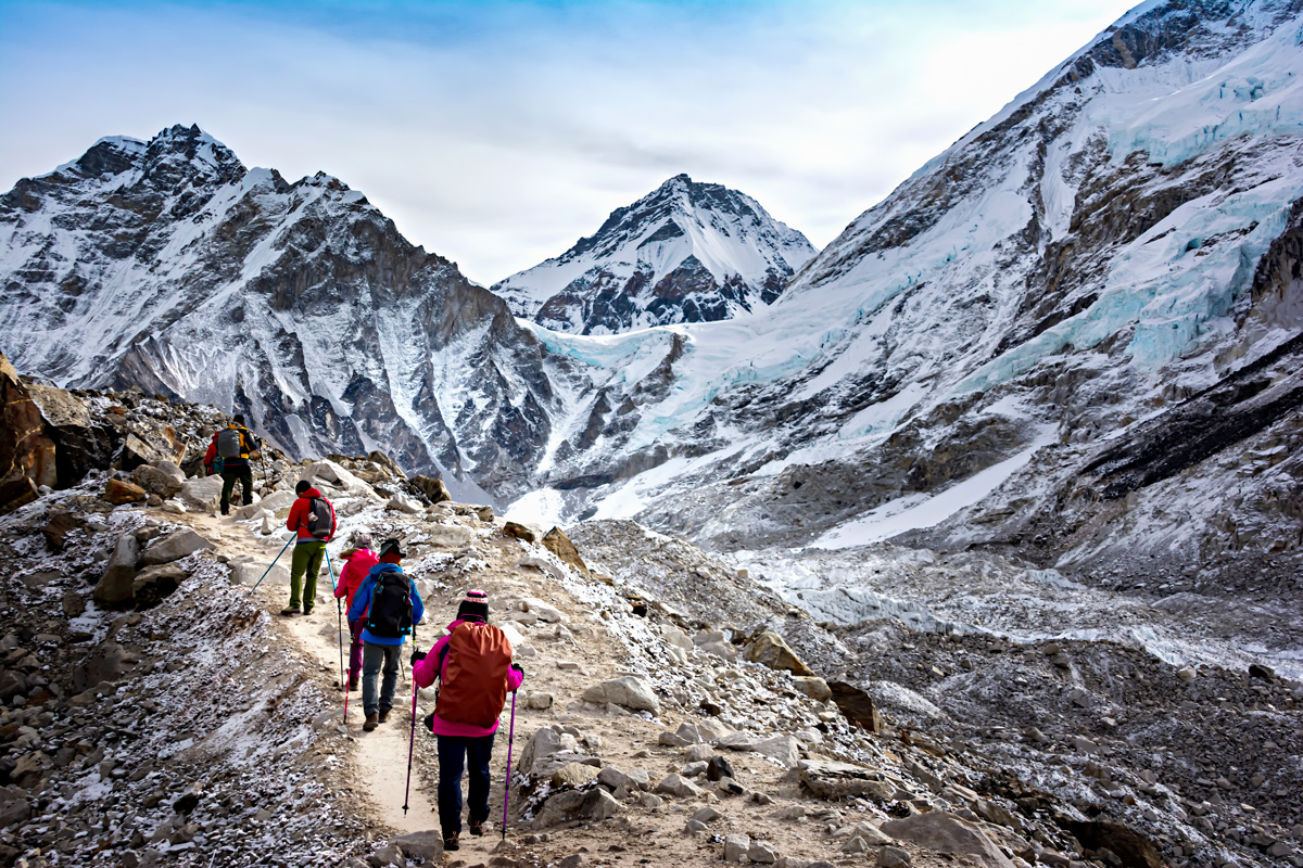 Group Of People Hiking In Snowy Mountains