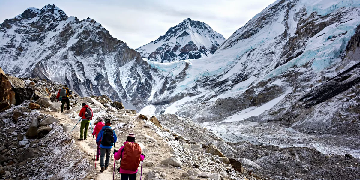 Group Of People Hiking In Snowy Mountains