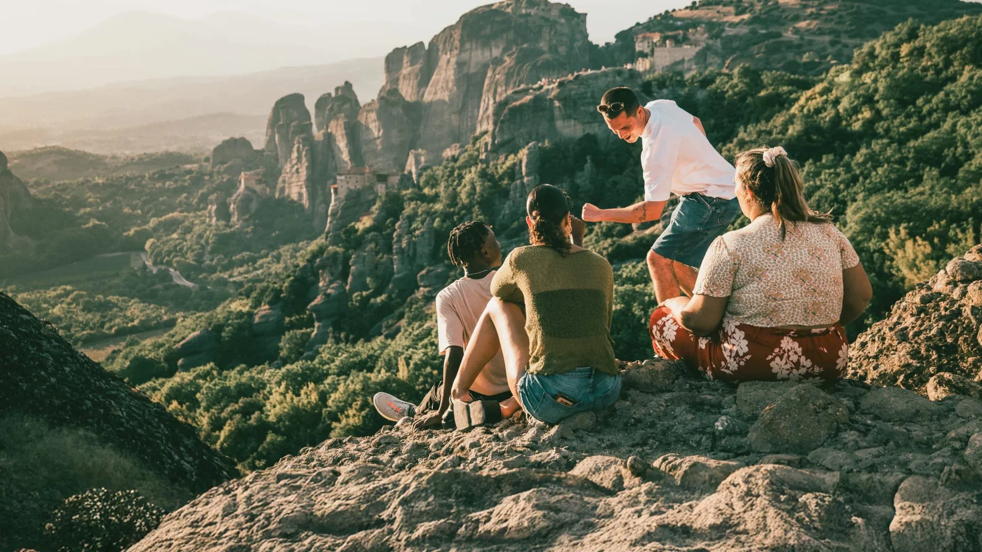 Travellers take in panoramic views of Meteora's cliff-top monasteries during Contiki's Greece: Athens, Delphi & Meteora Tour