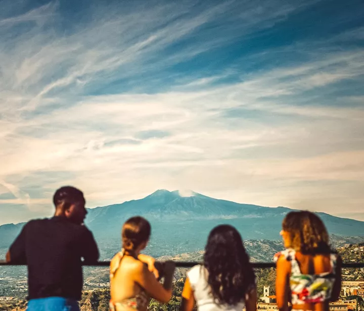 Travellers enjoying the volcano views in Sicily, Italy