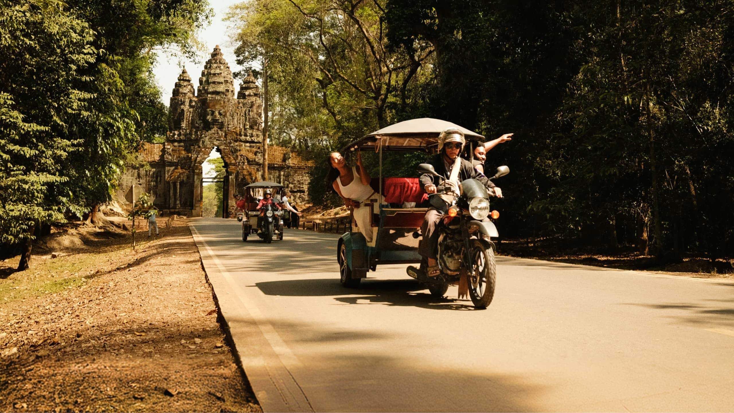 Contiki travellers exploring Angkor Thom by tuk-tuk on Contiki's Ride Cambodia Tour