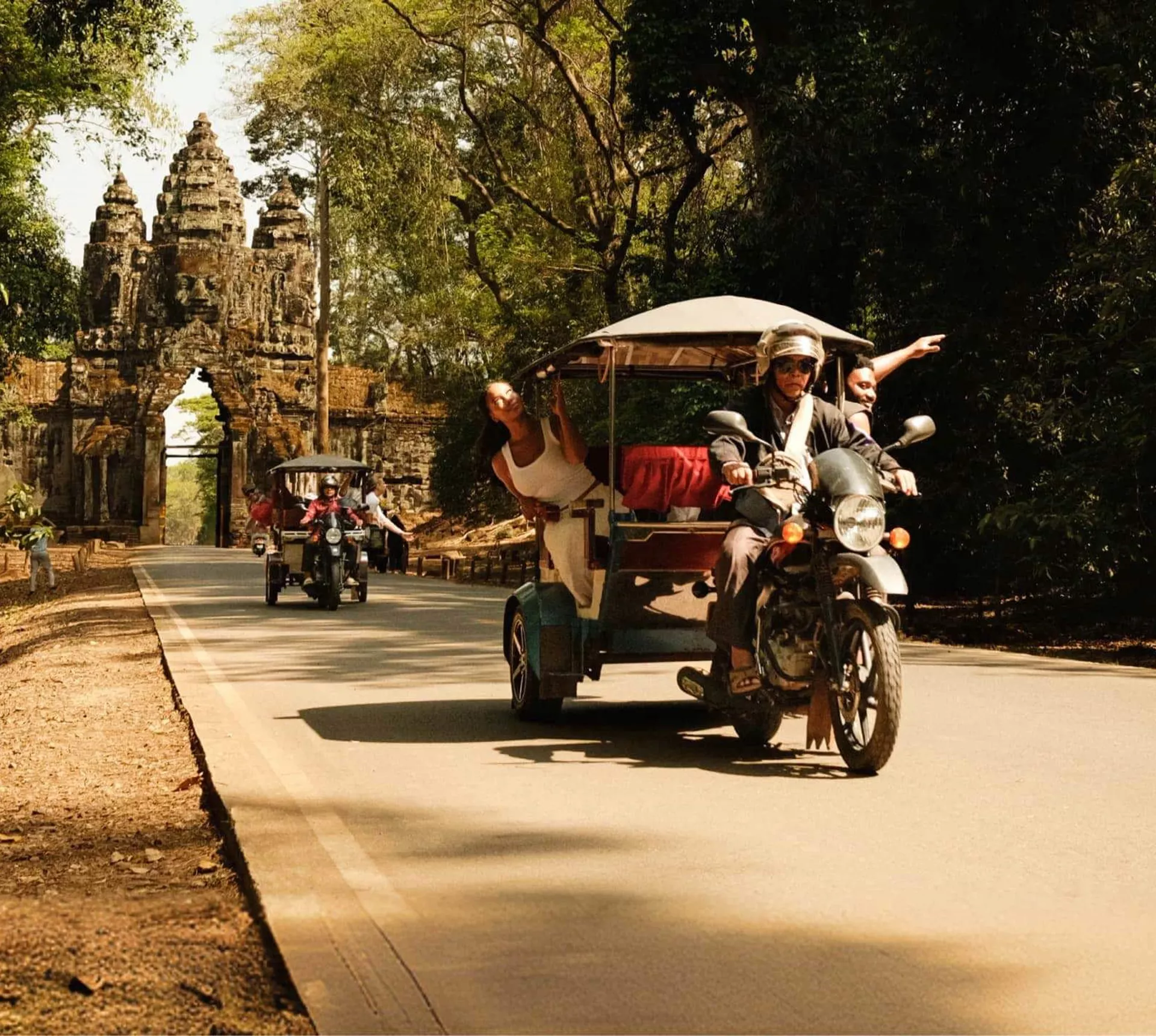 Contiki travellers exploring Angkor Thom by tuk-tuk on Contiki's Ride Cambodia Tour