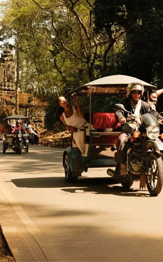 Contiki travellers exploring Angkor Thom by tuk-tuk on Contiki's Ride Cambodia Tour