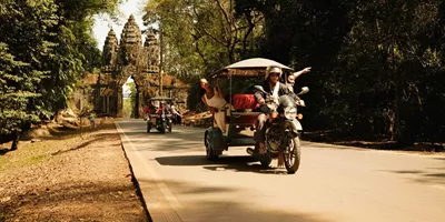 Contiki travellers exploring Angkor Thom by tuk-tuk on Contiki's Ride Cambodia Tour