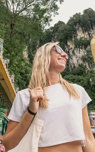 Traveller explores Batu Caves and the golden Lord Murugan statue on the Contiki Thailand, Malaysia & Singapore Tour