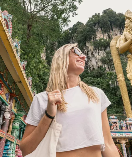 Traveller explores Batu Caves and the golden Lord Murugan statue on the Contiki Thailand, Malaysia & Singapore Tour