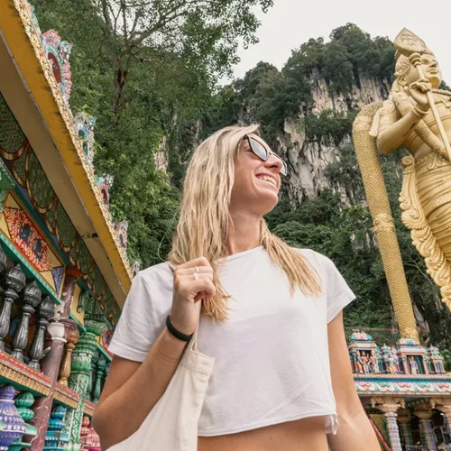 Traveller explores Batu Caves and the golden Lord Murugan statue on the Contiki Thailand, Malaysia & Singapore Tour