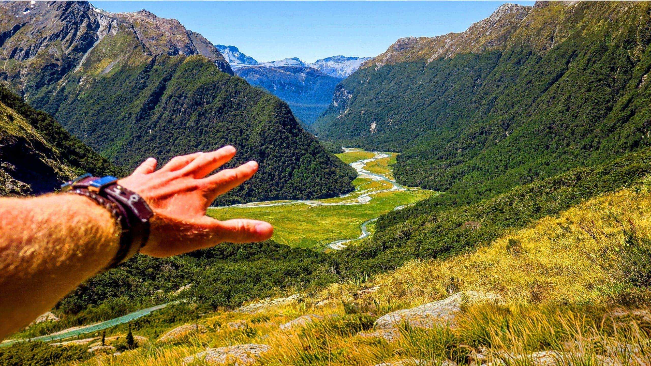 Panoramic view of a mountain valley and winding river in New Zealand on the Contiki Active New Zealand Tour