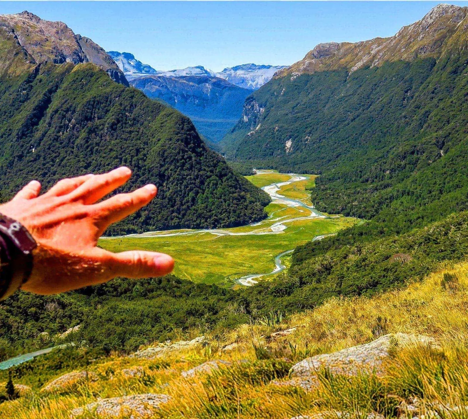 Panoramic view of a mountain valley and winding river in New Zealand on the Contiki Active New Zealand Tour