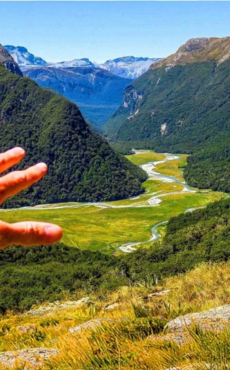 Panoramic view of a mountain valley and winding river in New Zealand on the Contiki Active New Zealand Tour