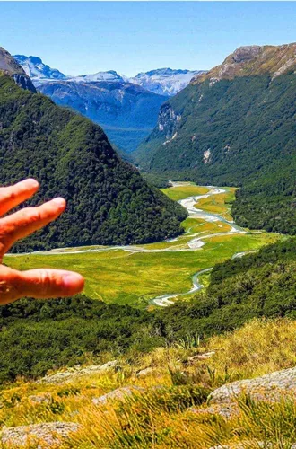 Panoramic view of a mountain valley and winding river in New Zealand on the Contiki Active New Zealand Tour