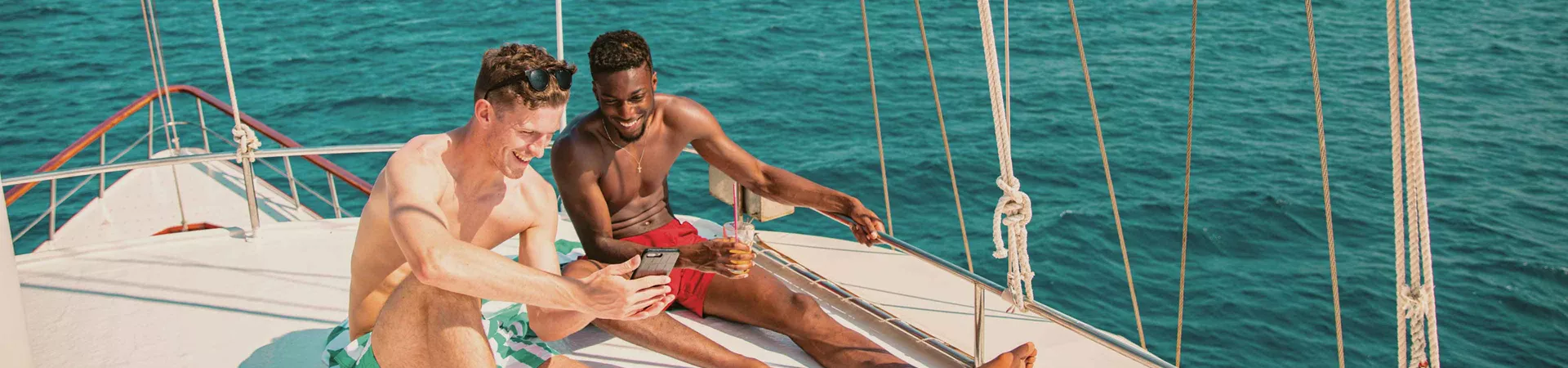 Two Males Enjoying Sun On Yacht
