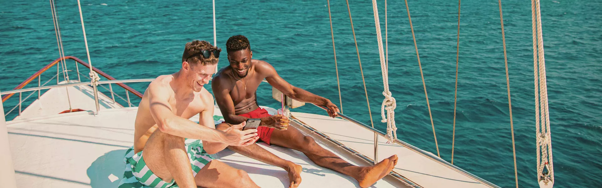 Two Males Enjoying Sun On Yacht