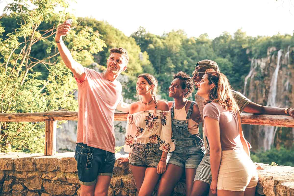 Group Young People Taking Selfie With A Nature Landscape At The Background