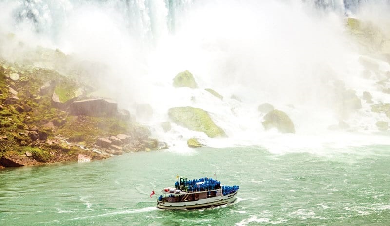 A ship full of tourists flowing near Niagara Falls