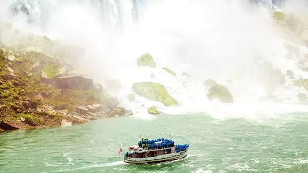 A ship full of tourists flowing near Niagara Falls
