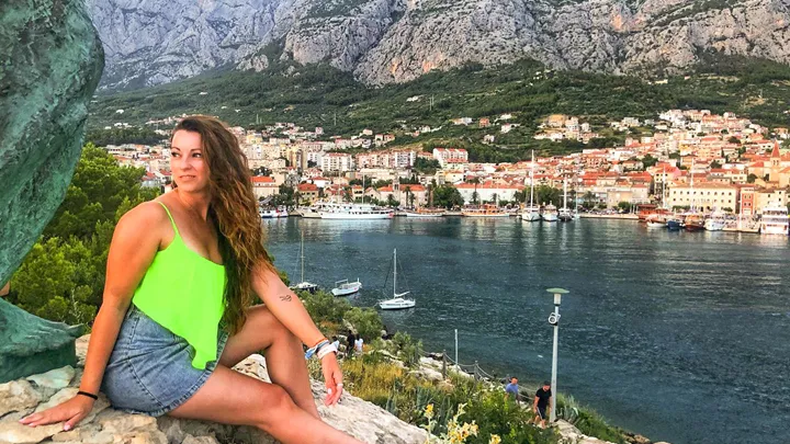 Traveller sat at viewpoint of Makarska in Croatia