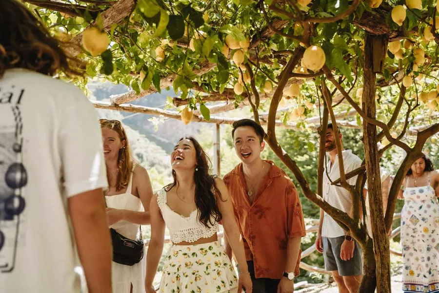 Friends Smiling Under A Yellow Lemon Tree