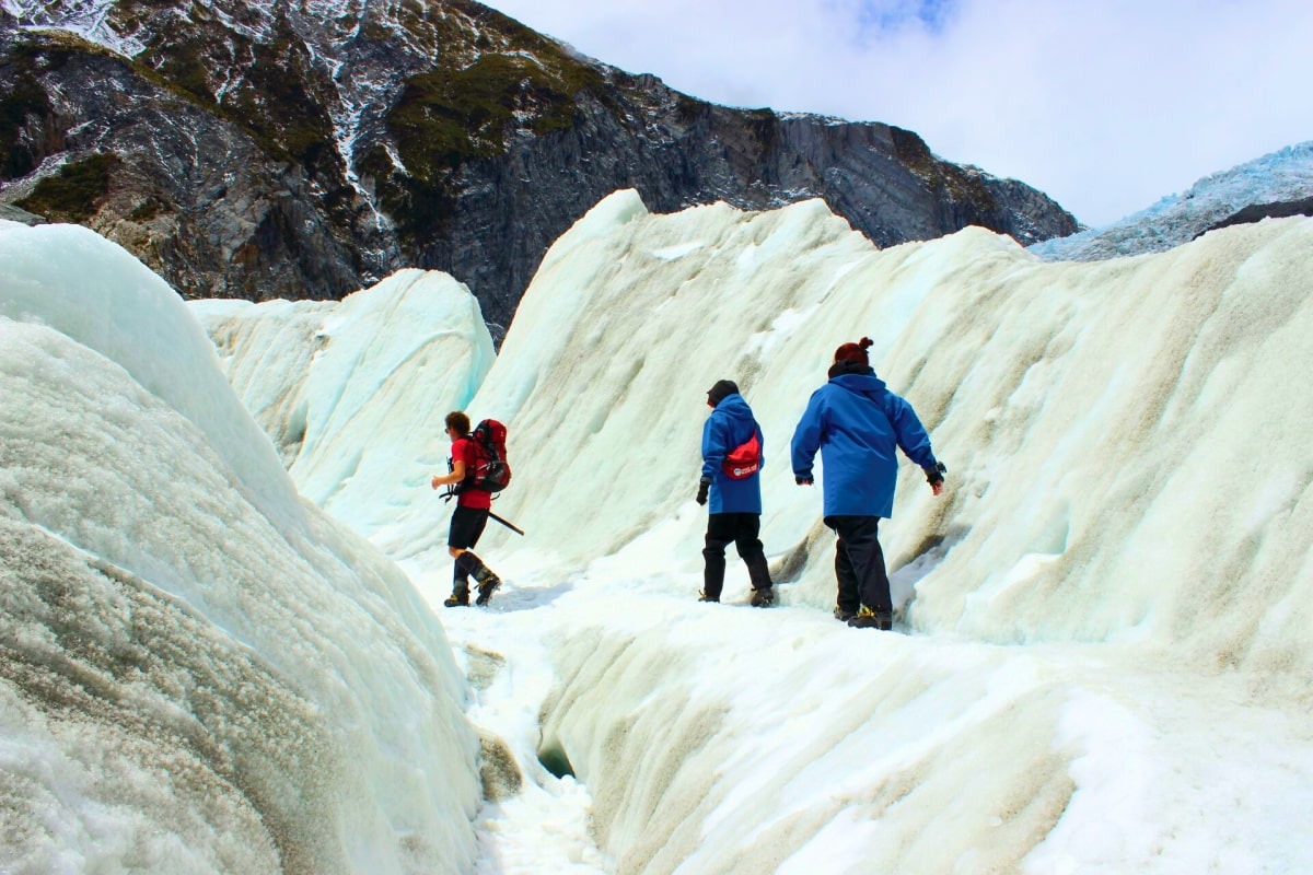 Three man walking in ice mountain in New Zealand.
