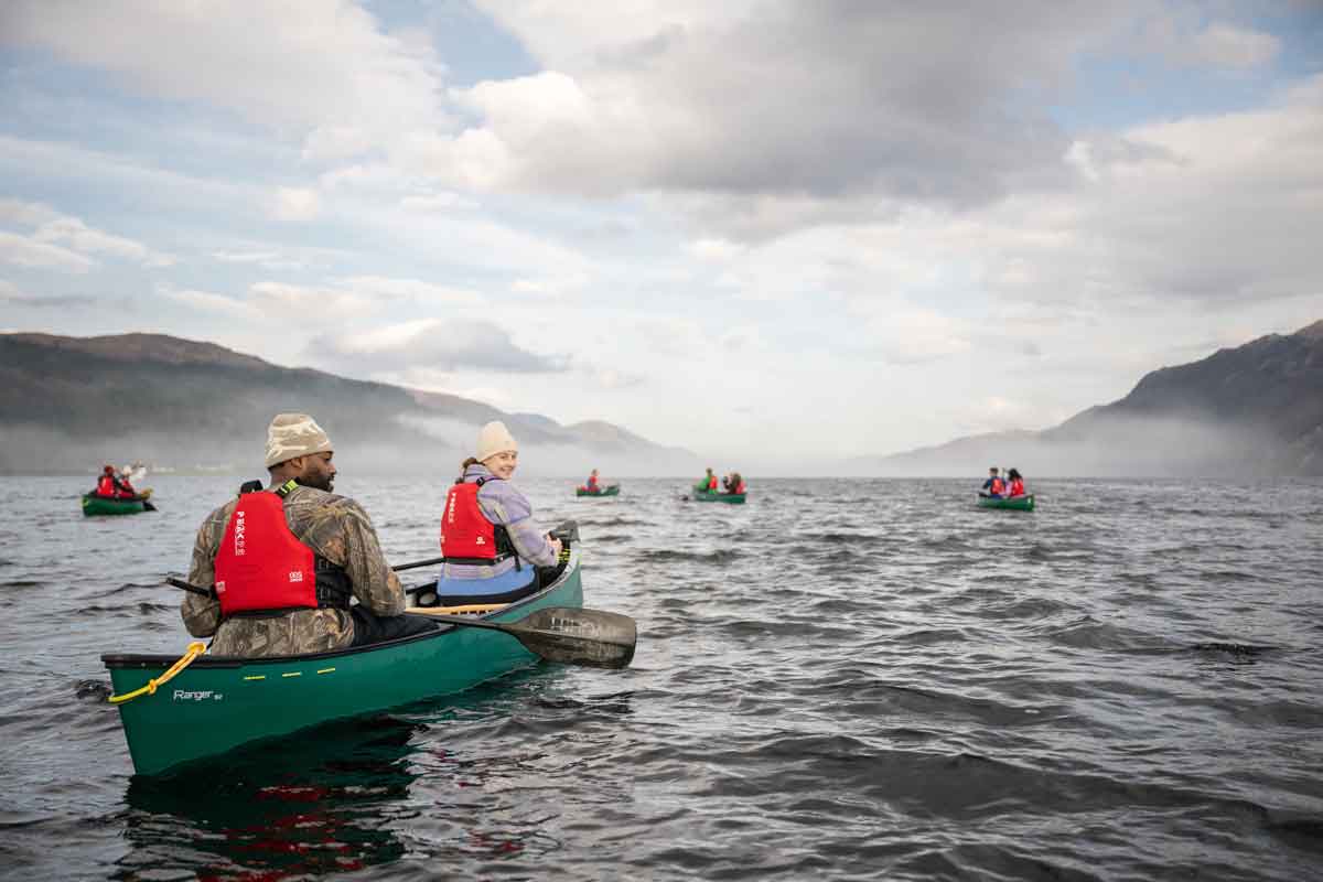 People kayaking on a lake in Scotland