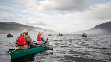 People kayaking on a lake in Scotland