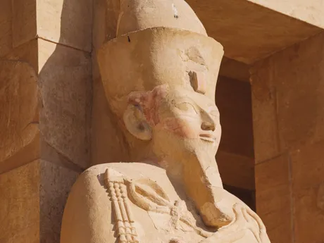 An ancient statue at the entrance of a tomb in Egypt