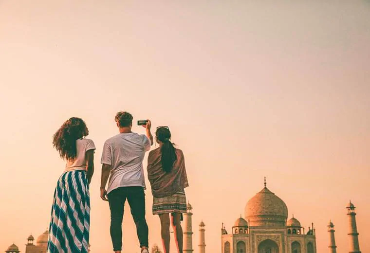 Friends taking pictures of Taj Mahal