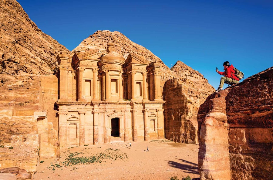 A Tourist Taking Picture of an Ancient Temple