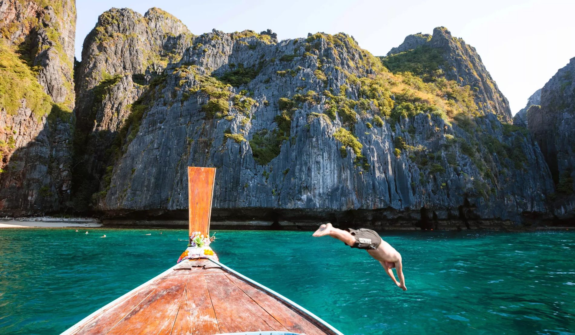 Man Diving From Boat Prow Phi Phi Island