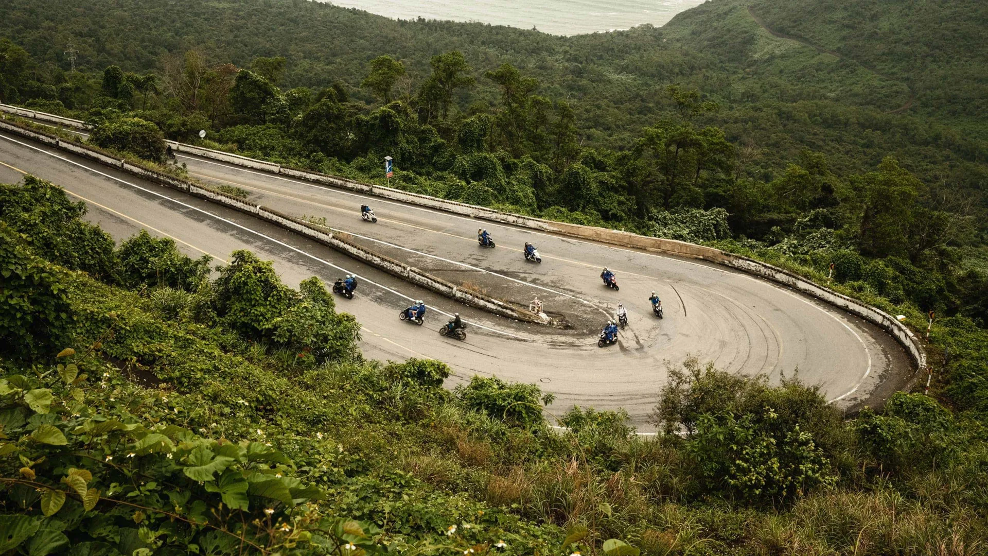 Contiki travellers riding scooters along Vietnam's iconic Hải Vân Pass on Contiki's Ride Vietnam Tour