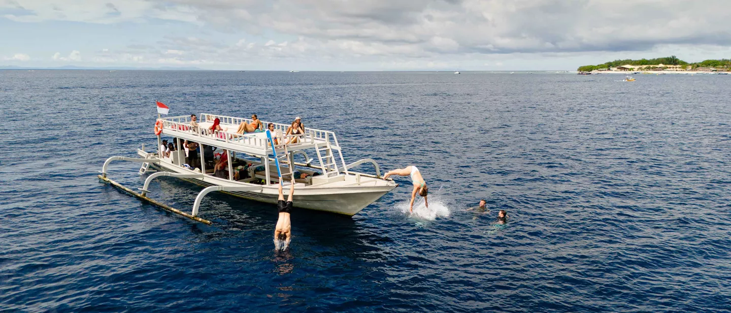 Group Of Young Travelers On Boat Indonesia