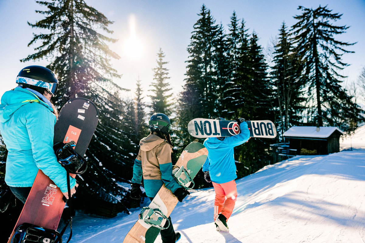 People With Snowboards On Mountain